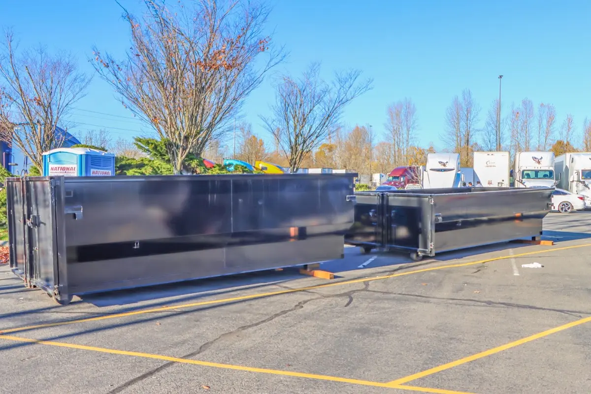 Professional dumpster rental service with roll-off container on residential driveway in Solon